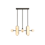 The Clérachic Alabaster 5-Light Linear Island Pendant lit head-on, warm light glowing evenly through both stone capsules and all three globes.