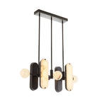 Angled view of the lit Clérachic Alabaster 5-Light Linear Island Pendant, dark bronze backplates sitting behind each glowing alabaster capsule.