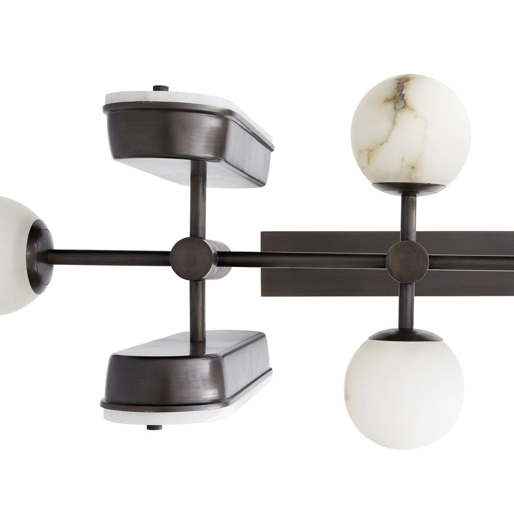 Close detail of the Clérachic Alabaster 5-Light Linear Island Pendant, showing the machined bronze cross joints and grey-veined stone globes.