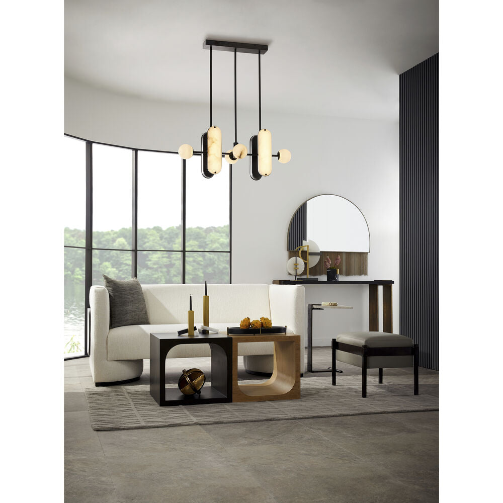 Full room view with the Clérachic Alabaster 5-Light Linear Island Pendant lit over low coffee tables, its bronze canopy flush to the ceiling.