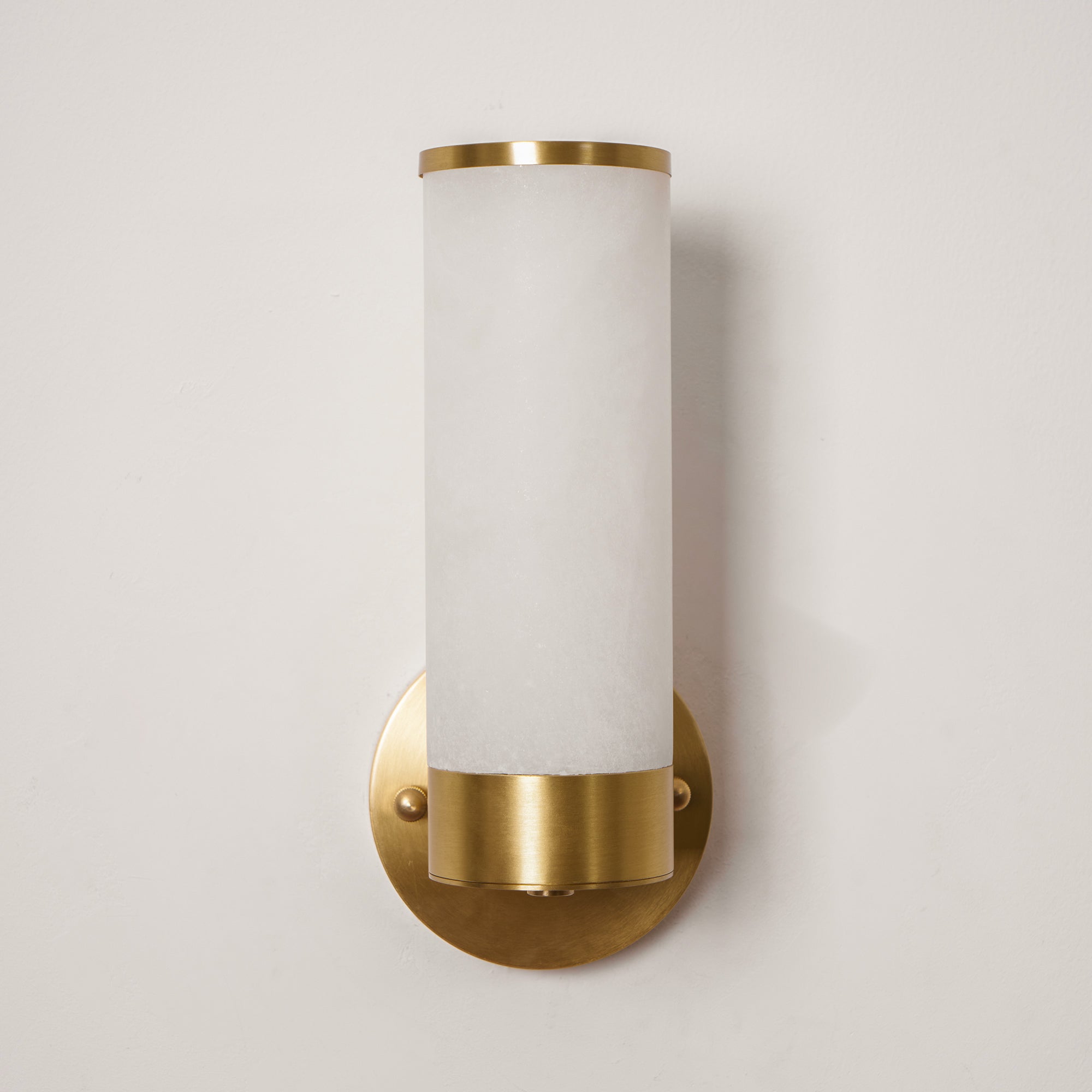 Clérachic Alabaster and Brass Wall Sconce seen straight on, a brass ring capping the stone above a round backplate.