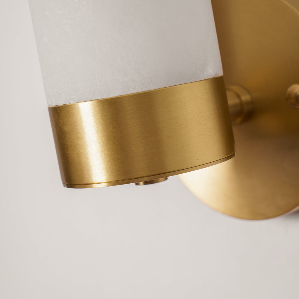 Detail of the Clérachic Alabaster and Brass Wall Sconce where the cut stone shade meets the brushed brass collar.