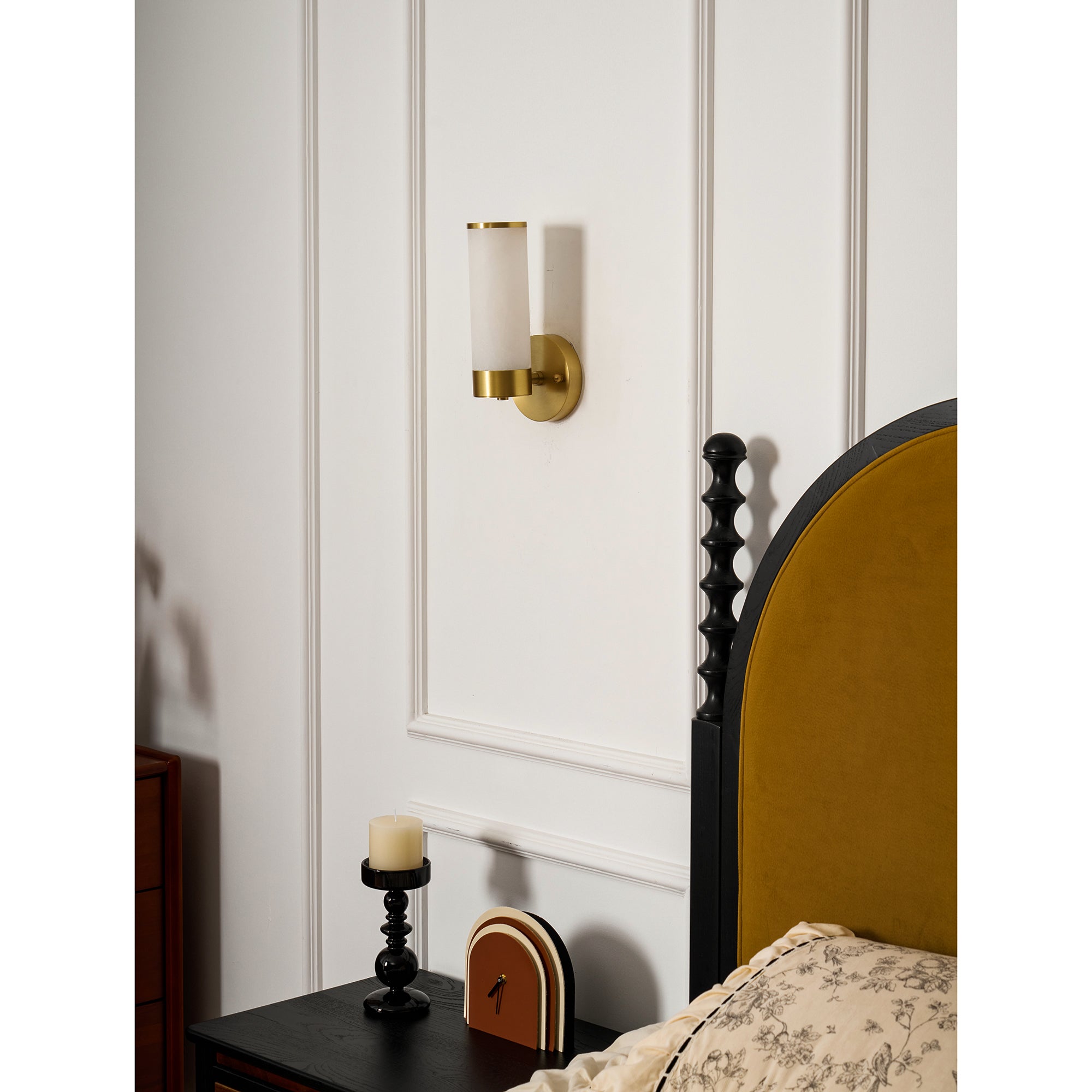 Clérachic Alabaster and Brass Wall Sconce unlit on bedroom panelling, reading as quiet hardware next to the headboard.