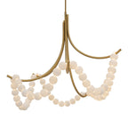 Clérachic Alabaster Bead Chandelier in brushed brass, its five arms carrying swagged strands of lit alabaster beads.
