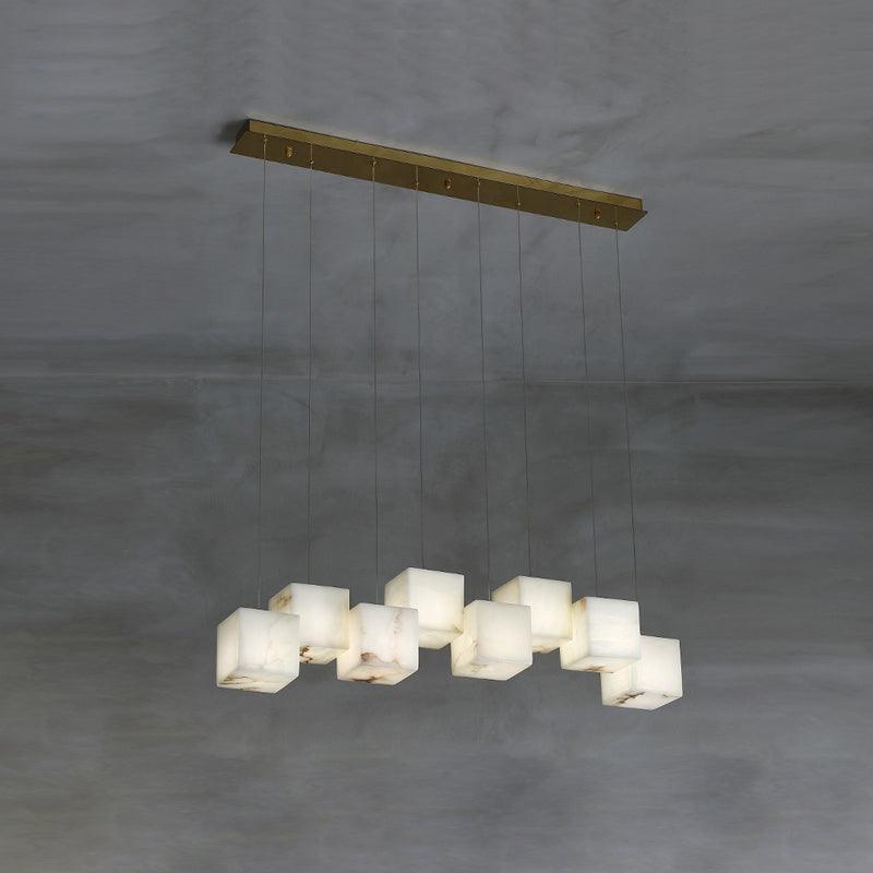 The nine-cube Clérachic box chandelier, alabaster boxes staggered along a long brass bar.