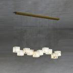 Clérachic box chandelier with eleven cubes spread across a wide brass ceiling plate.