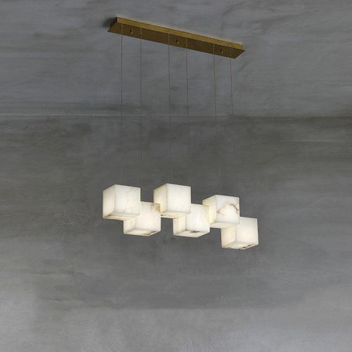 Clérachic alabaster box pendant, six cube shades on cables from a brass ceiling bar.