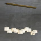 Clérachic box pendant at fifteen cubes, spread across a wide brass ceiling plate.