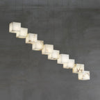 Clérachic box pendant running diagonally across concrete, cubes stepped along the cable line.