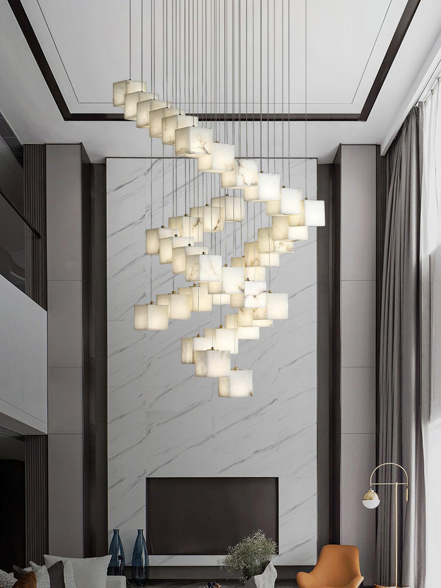 The Clérachic box pendant spiralling down a double-height marble wall above a fireplace.