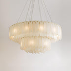 Clérachic cascade chandelier seen level, its two tiers of alabaster blades lit from within.