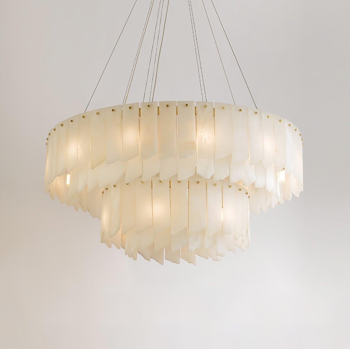 Clérachic cascade chandelier seen level, its two tiers of alabaster blades lit from within.