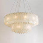 The two-tier Clérachic cascade chandelier on white, blades layered around the brass rim.