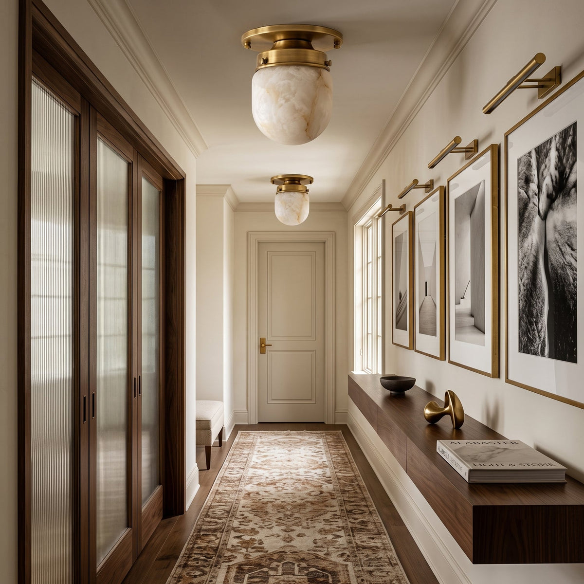 Two of these Clérachic alabaster flush mounts in a long hallway, with framed black-and-white prints and a patterned runner below.