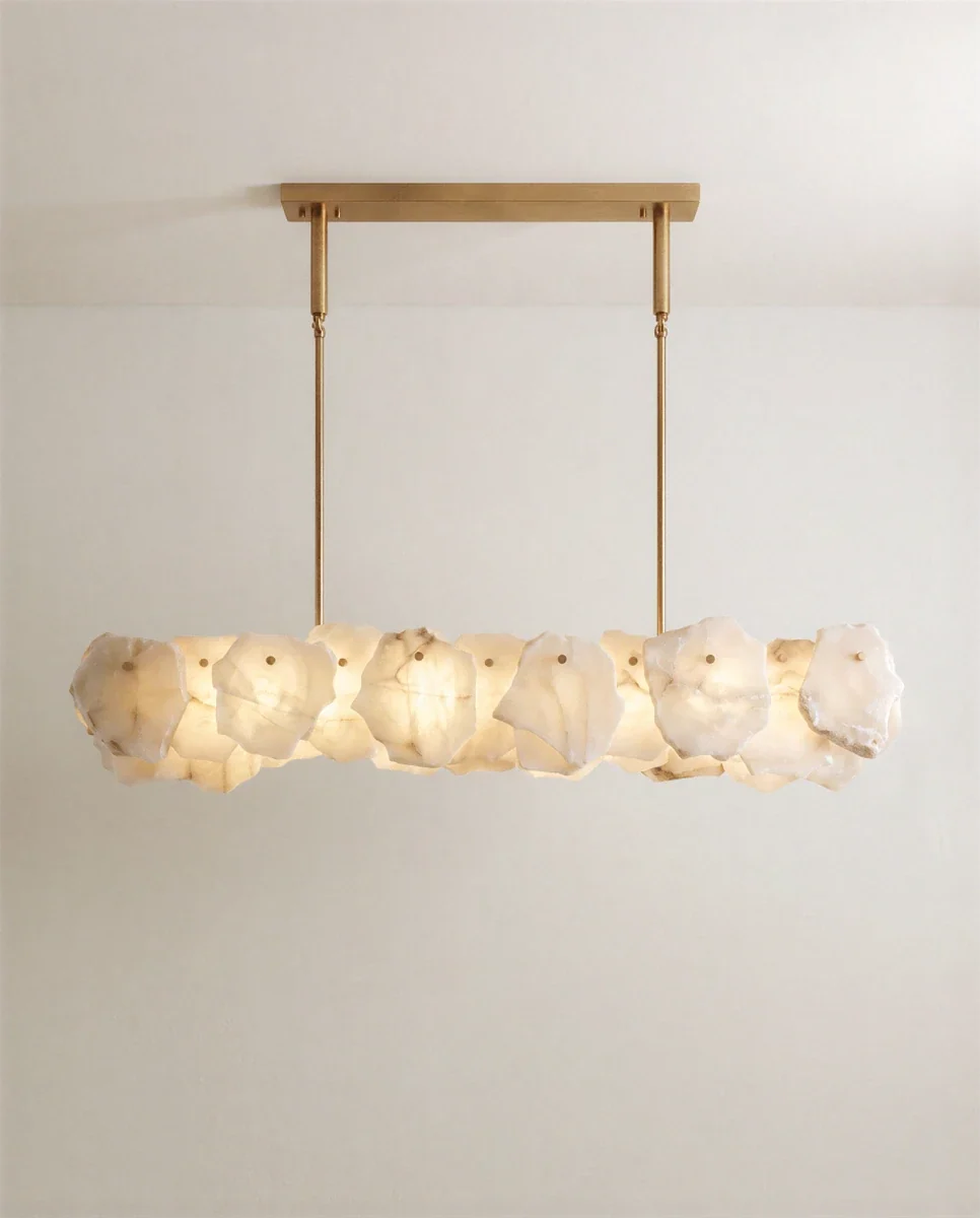 Clérachic linear chandelier of rough-edged alabaster panels, suspended by two slim brass rods from a rectangular brass canopy.