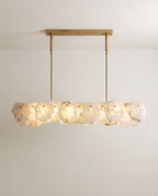 Clérachic linear chandelier of rough-edged alabaster panels, suspended by two slim brass rods from a rectangular brass canopy.