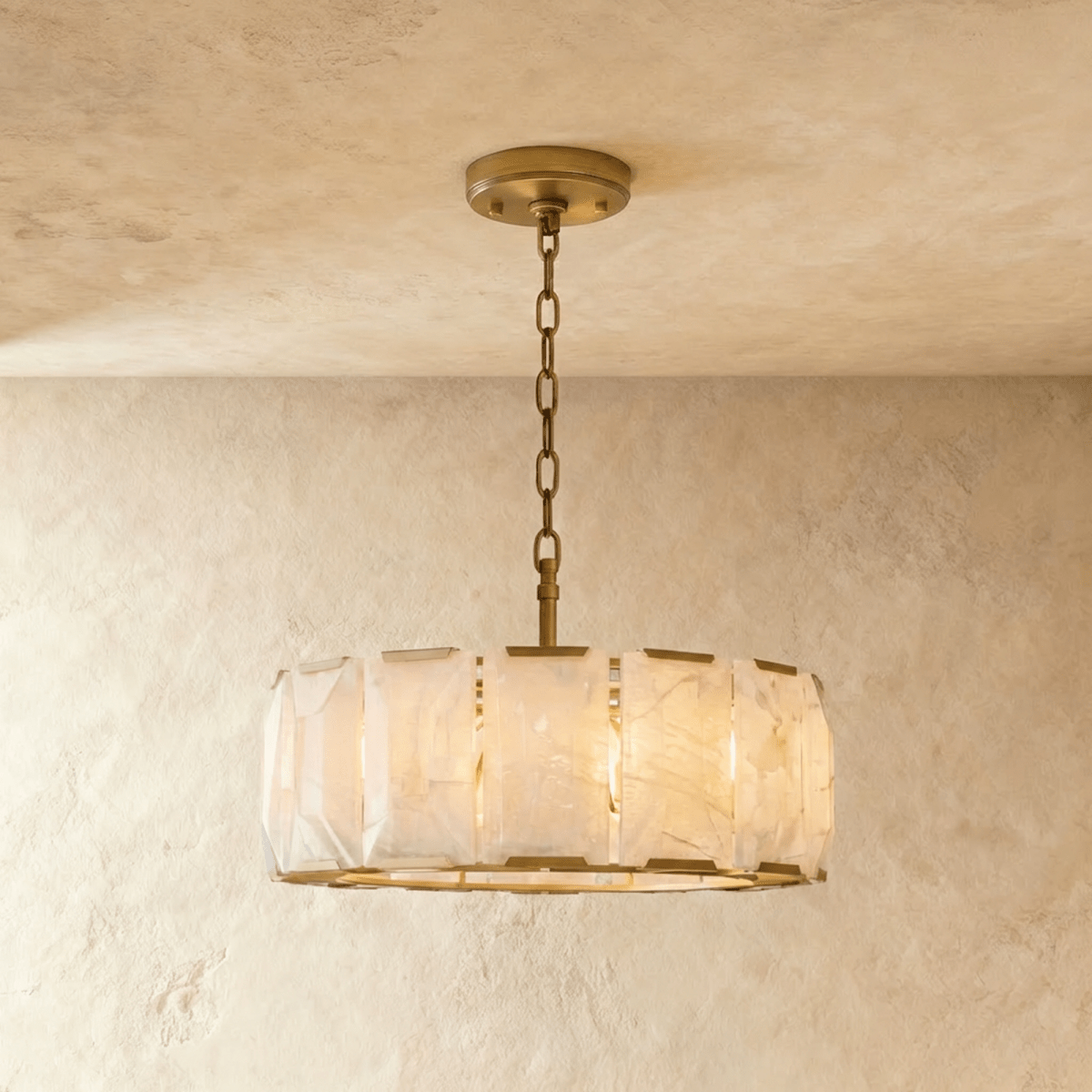 Clérachic alabaster chandelier, 78 cm wide, in lacquered burnished brass, lit warm against limewashed plaster