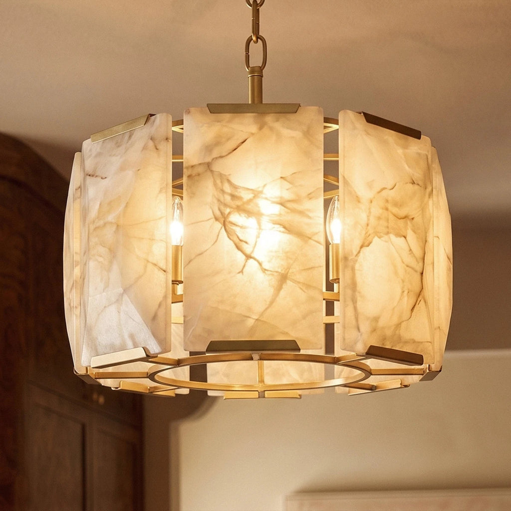 Close view of Clérachic alabaster panels in a brass frame, lit from inside to show warm amber veining