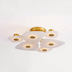 Clérachic Alabaster Cluster Ceiling Light in its round six-shade version, lit warm against a white living-room ceiling.