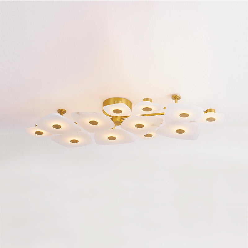 Angled view of the linear Clérachic Alabaster Cluster Ceiling Light, brass arms fanning warm light along a hallway ceiling.