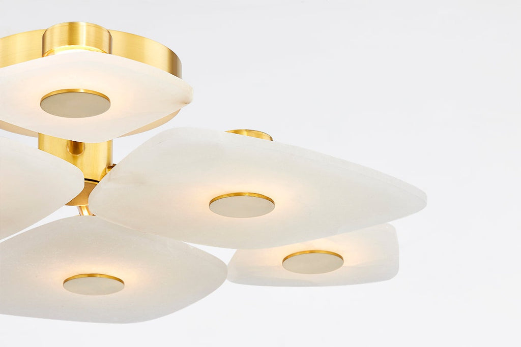 Close detail of the Clérachic Alabaster Cluster Ceiling Light, warm light washing through the alabaster around each brass disc.