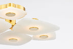 Close detail of the Clérachic Alabaster Cluster Ceiling Light, warm light washing through the alabaster around each brass disc.