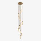 A brass-fitted cascade of alabaster columns hangs from this Clérachic chandelier, glowing warm on a plain background.