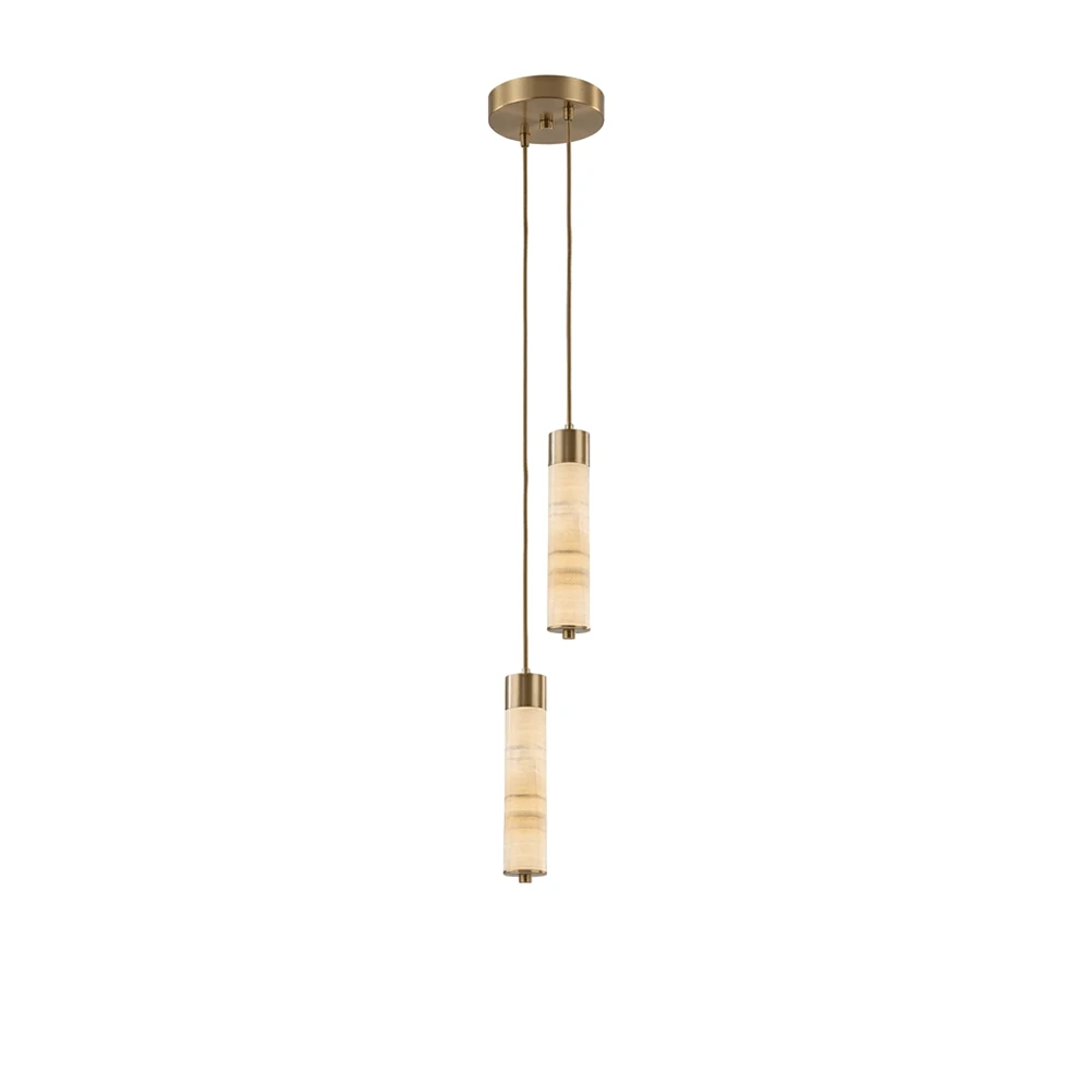 Two brass-capped alabaster columns on this Clérachic chandelier hang close together, glowing warm on a plain background.