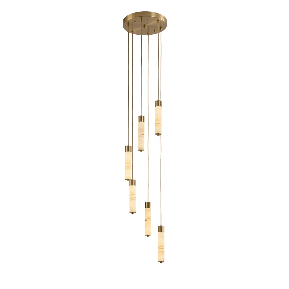 A loose cascade of brass-capped alabaster columns glows warm on this Clérachic chandelier, shown on a plain background.
