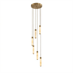 A loose cascade of brass-capped alabaster columns glows warm on this Clérachic chandelier, shown on a plain background.