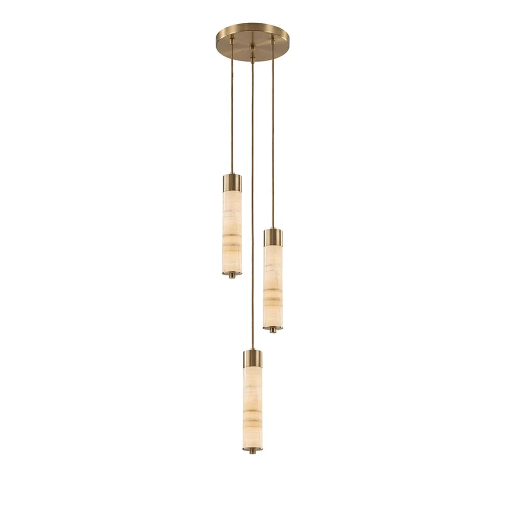 Three brass-capped alabaster columns glow warm on this Clérachic chandelier, staggered at different heights on a plain background.