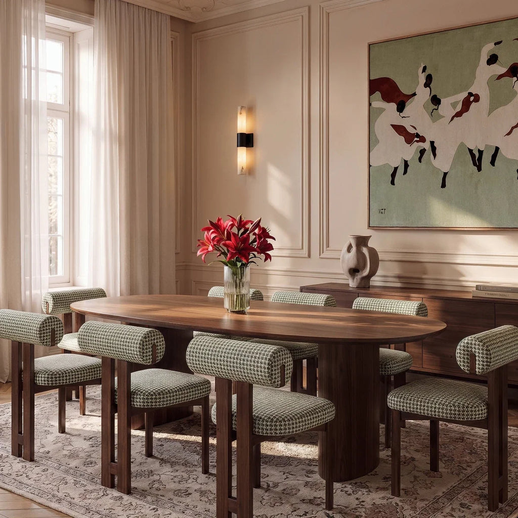 Clérachic wall sconce with a black band and alabaster column on a panelled wall above a walnut dining table.