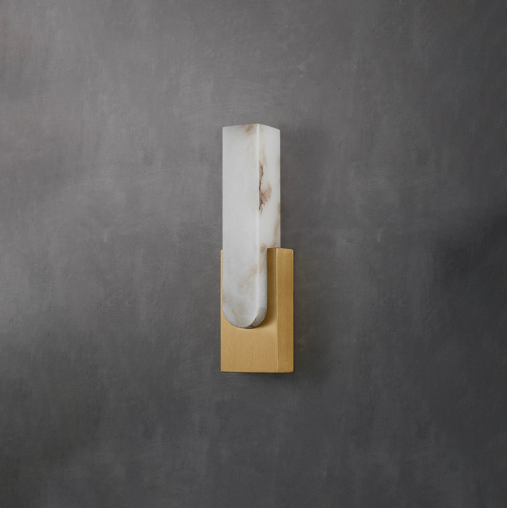 Unlit Clérachic wall light on a dark grey wall, a veined alabaster bar in a gold-toned bracket.