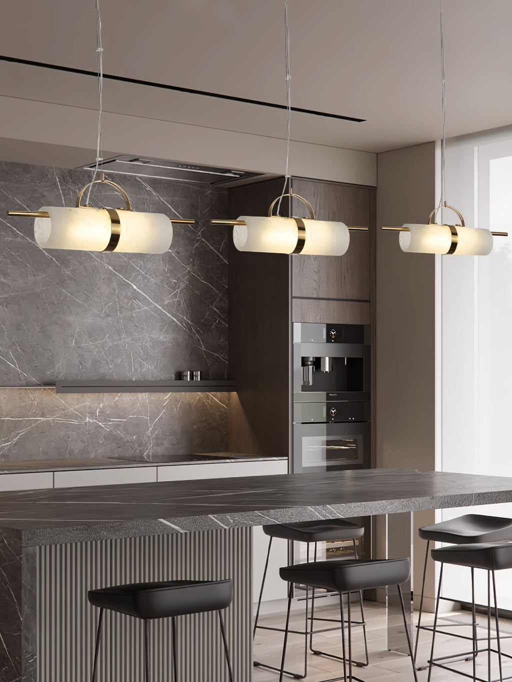 Three Clérachic Alabaster Cylinder LED Pendant Lights in a row over a grey stone kitchen island, lighting the full run of the counter.