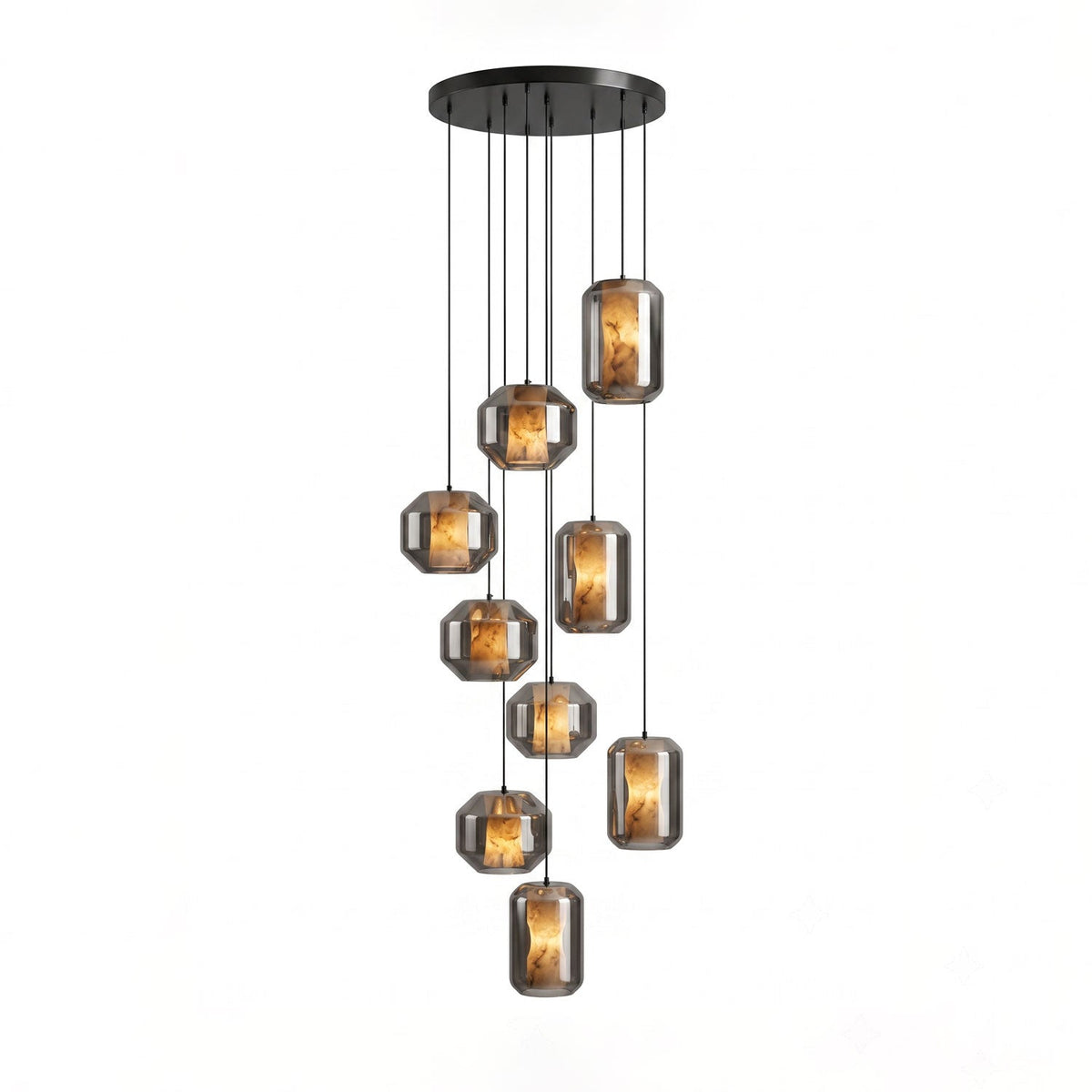 A larger cluster of smoke grey glass Clérachic pendants with amber-lit alabaster hangs at staggered heights from a round black canopy on white.