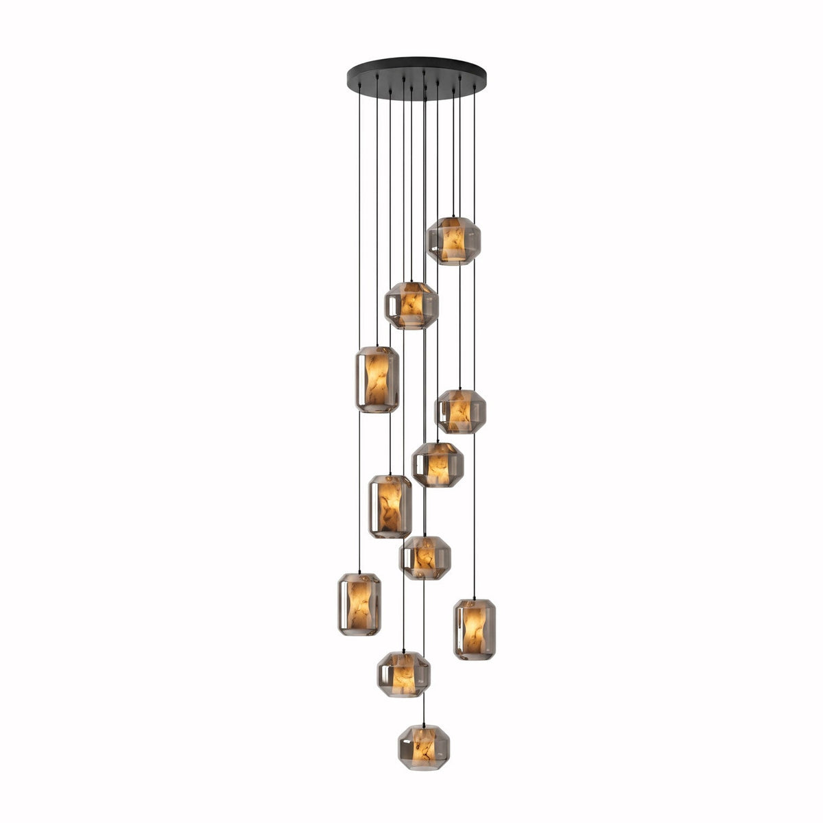 A long cluster of smoke grey glass Clérachic pendants hangs at many heights from a wide round black canopy on a white backdrop.