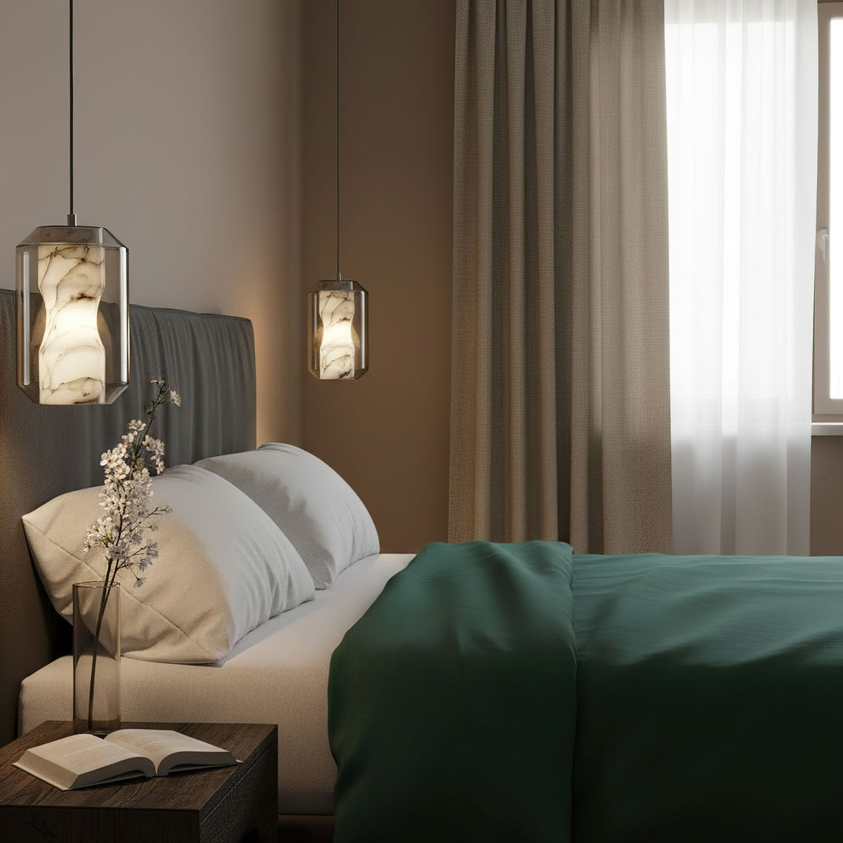 Two Clérachic alabaster pendants glow beside a bed with a green throw, one close to the camera and one further back by the curtains.