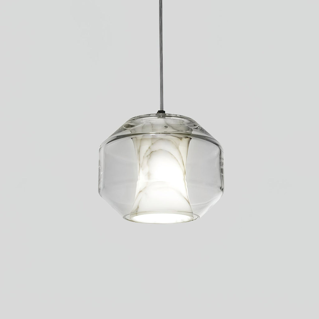 Front view of a wide, rounded-faceted Clérachic pendant on a pale grey backdrop, clear glass around a softly lit white alabaster core.