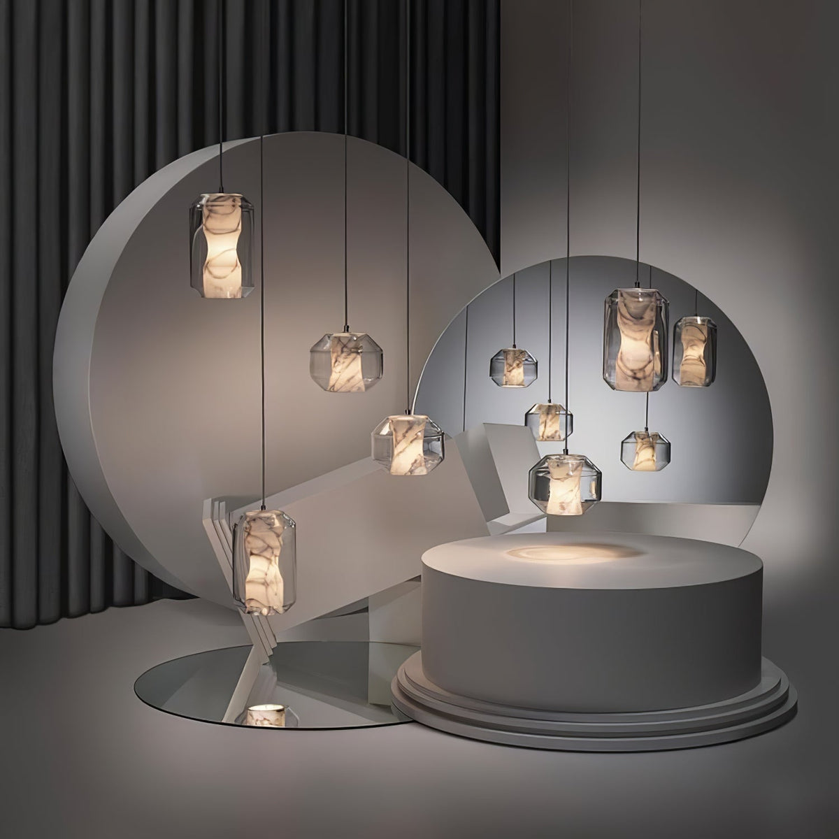 Wide view of a dark studio set where Clérachic alabaster pendants of different sizes hang around round discs and a pale circular plinth.