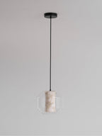 A wide Clérachic pendant hanging from a round black canopy against pale grey, its alabaster column glowing gently inside the glass.