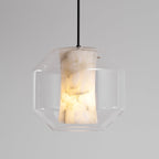 A wide Clérachic pendant on a black cord, its lit alabaster column veined in brown and cream inside a clear faceted glass shell.