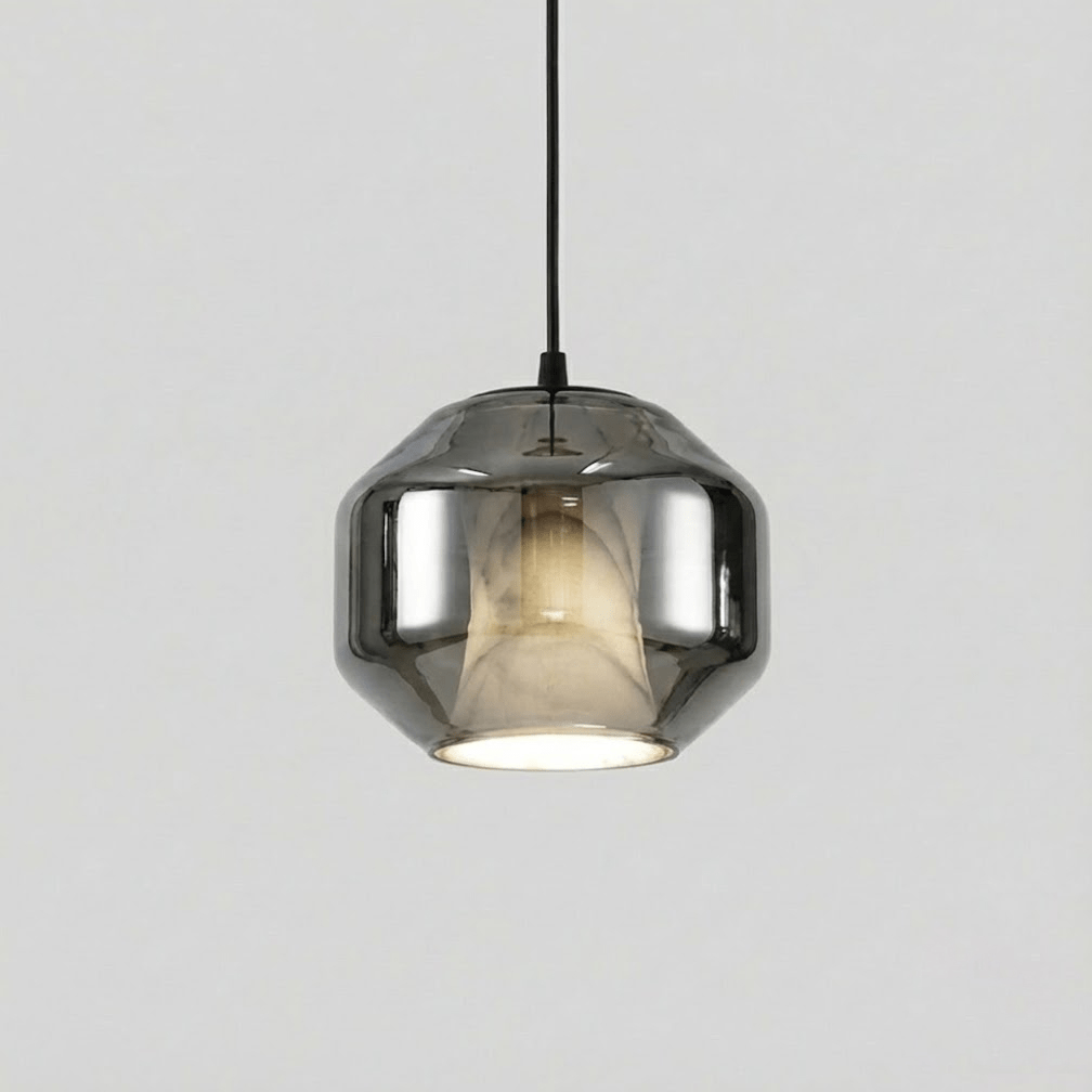 A wide Clérachic pendant with a smoke grey glass shell on a black cord, showing the pale alabaster inside, on a plain light grey backdrop.