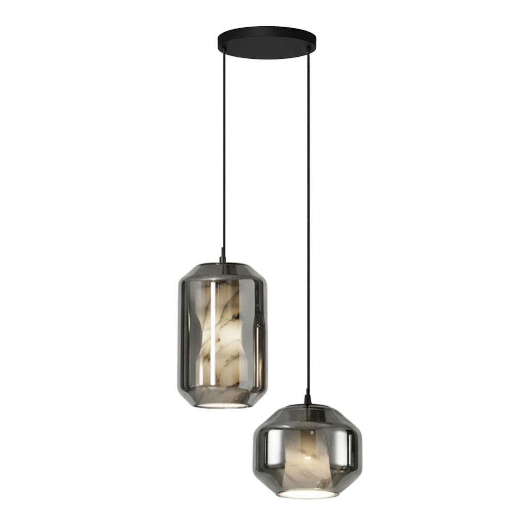 Two Clérachic pendants on a round black canopy, a tall and a wide one in smoke grey glass, hung at different drops on a white backdrop.