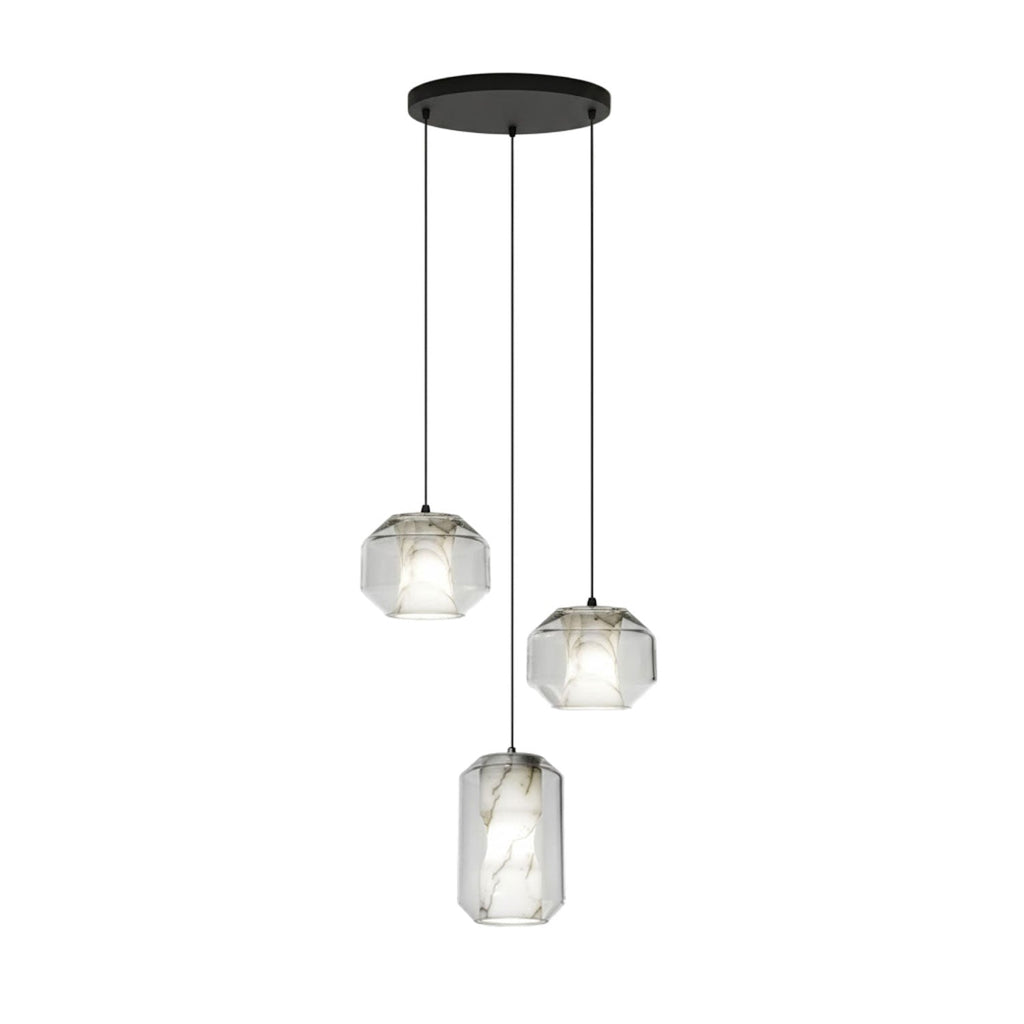 Three clear glass Clérachic pendants, two wide and one tall, hang at different heights from a round black canopy on a white backdrop.