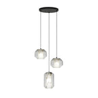 Three clear glass Clérachic pendants, two wide and one tall, hang at different heights from a round black canopy on a white backdrop.