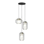 Three Clérachic pendants with clear glass and white alabaster, one wide and two tall, hang from a round black canopy on a white backdrop.