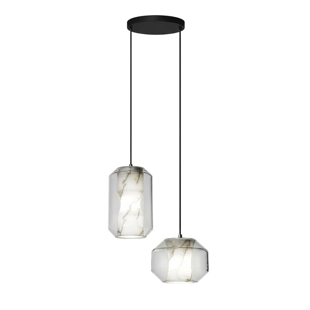 One tall and one wide Clérachic pendant with clear glass and white alabaster hang from a round black canopy on a white backdrop.