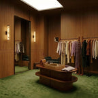 Two Clérachic alabaster wall lights glowing on oak-panelled walls in a walk-in wardrobe with green carpet and a clothing rail.