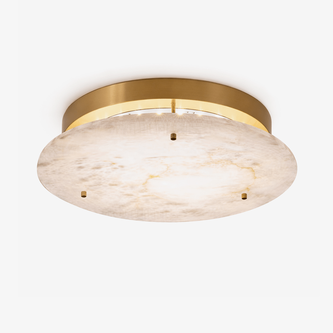 Clérachic alabaster disc ceiling light with a brass canopy and three small brass studs, seen from below on a plain white backdrop.