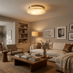 Clérachic flush-mount disc light overhead in a warm living room with built-in shelves, a floor lamp and framed art on the walls.